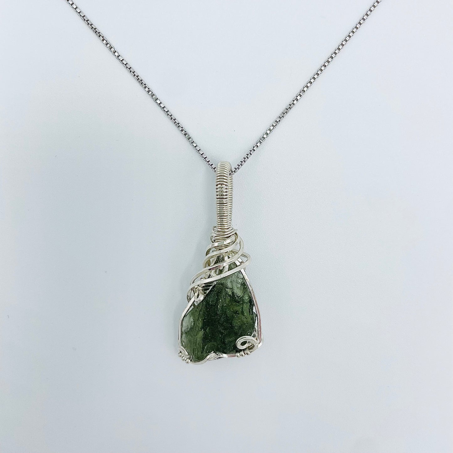 Argentium Silver Wrapped Moldivite on an 18” Rhodium Plated Sterling Silver Box Chain.