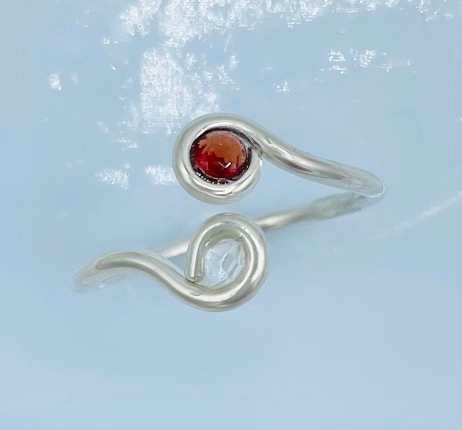 Argentium silver with A faceted Garnet on one side