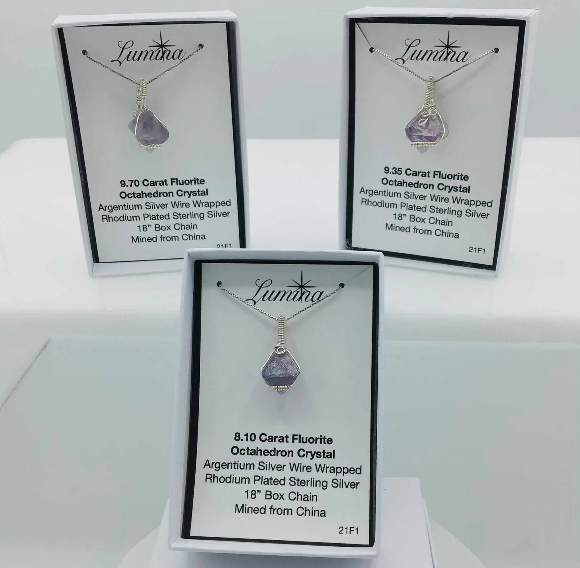 Three Argentium Silver Wire Wrapped Fluorite Octahedron Crystals on Rhodium Plated Sterling Silver Box Chains . (Left to right on top: 1st is mini horizontal coil, 2nd is Large Horizontal Crystal, bottom 3rd crystal:  1st is mini horizontal coil,)