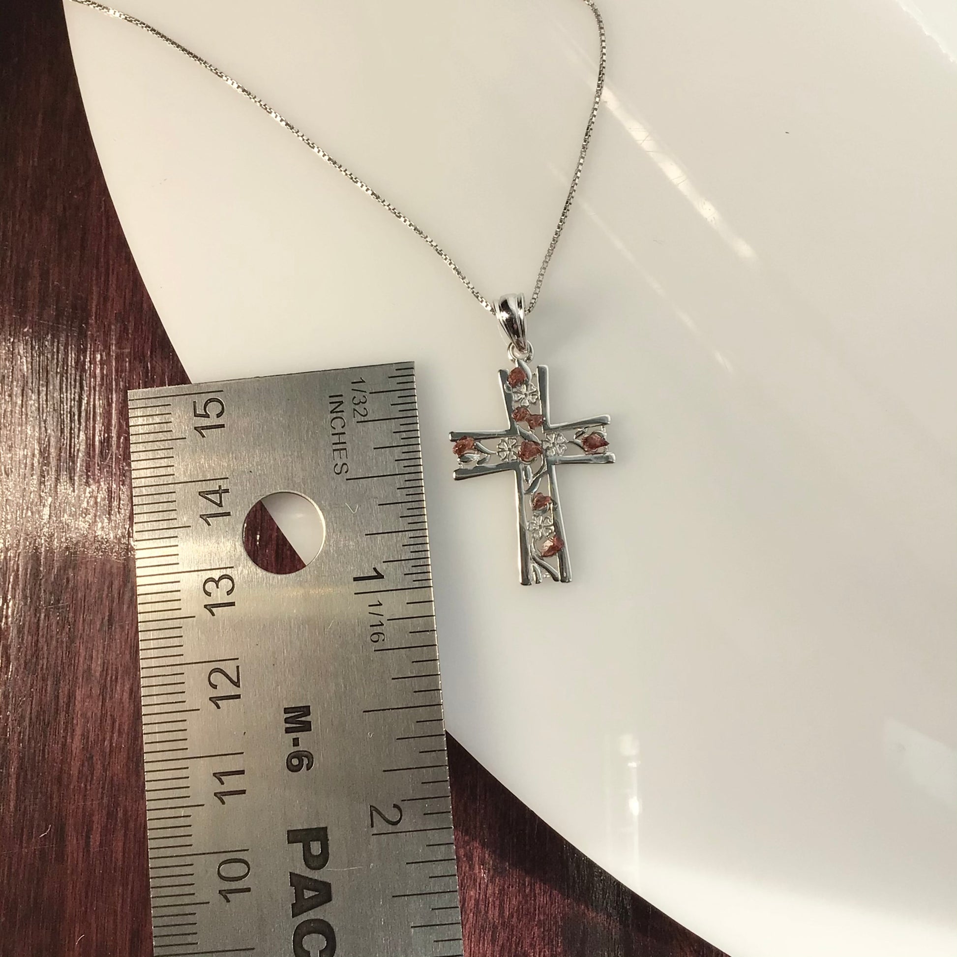 0.25 Total Carat Weight (TCW) Garnet on a Rhodium Plated Sterling Silver Cross & Rhodium Plated Sterling Silver 18” Box Chain