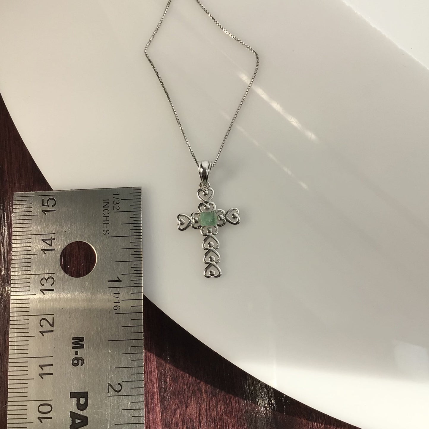 0.40 Carat Green Tourmaline on a Rhodium Plated Sterling Silver Cross and Rhodium Plated Sterling Silver 18” Box Chain.