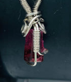 Side view of Bi-Color Pink Tourmaline, wrapped in Argentium Silver, on an 18” Rhodium Plated, Sterling Silver Box Chain
